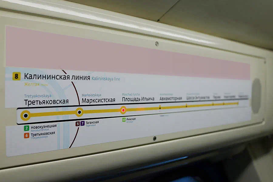 На рисунке видно, что рядом со стороны поезда находится знак с картой. Этот знак установлен на стене, на нем написаны текст и цифры, что, вероятно, указывает маршрут движения поезда.