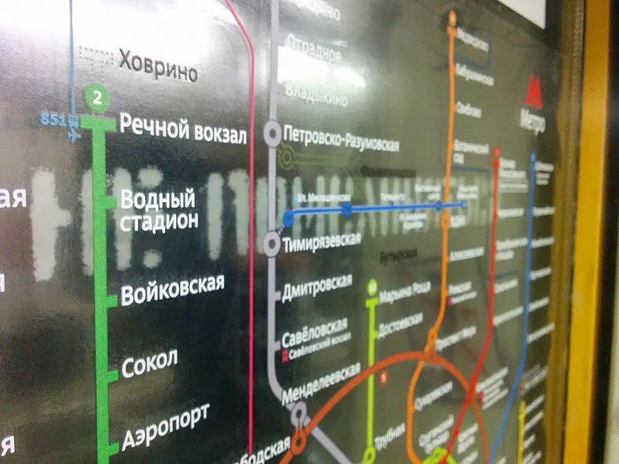 Карта показывает близость карты метро на стене станции метро. Карта представляет собой подробное представление системы московской метро с четко различимыми текстами и маршрутами.